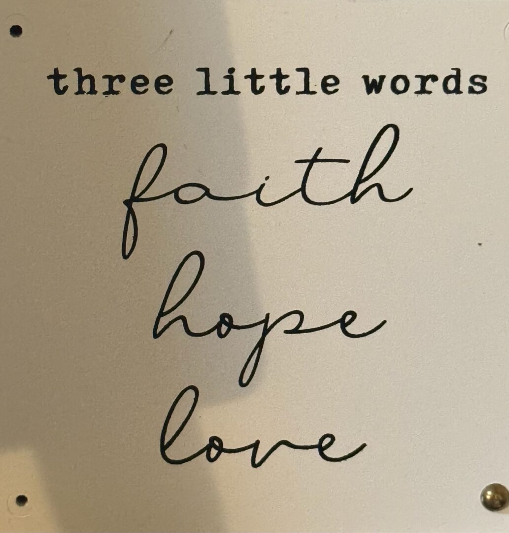 Decorative sign reading faith, hope, love