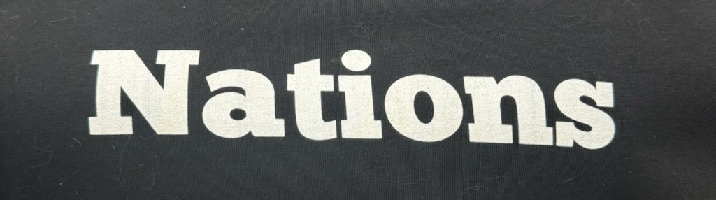 White "Nations" text on black shirt