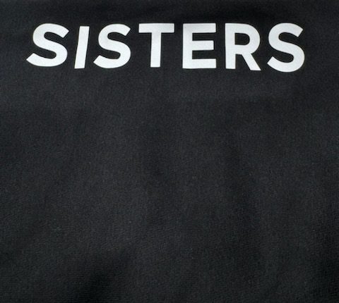 Black tee with white SISTERS lettering