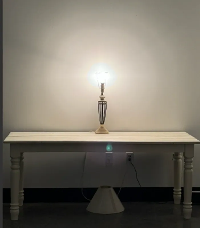 Lit decorative lamp on wooden console table