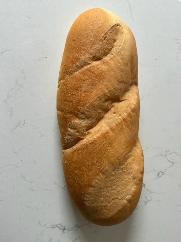 Rustic golden loaf on marble countertop